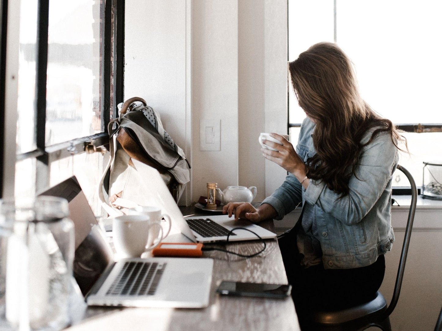 woman working on laptop drinking coffee for performance